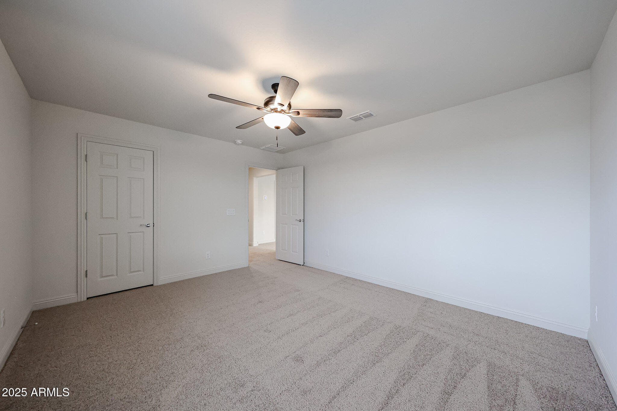 7072 West Oberlin Way Peoria, AZ 85383 - Photo 19 of 24 a view of an empty room with a ceiling fan