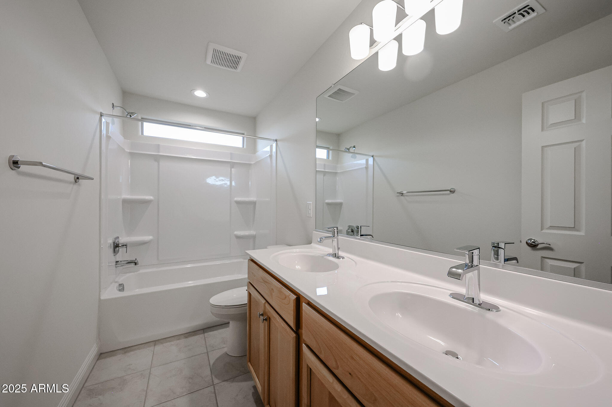 7072 West Oberlin Way Peoria, AZ 85383 - Photo 20 of 24 a bathroom with a sink a toilet a mirror and shower