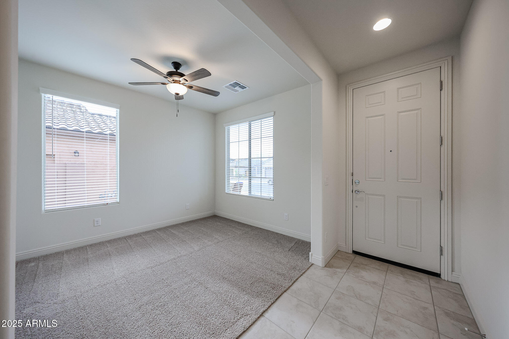 7072 West Oberlin Way Peoria, AZ 85383 - Photo 2 of 24 a view of an empty room with a window