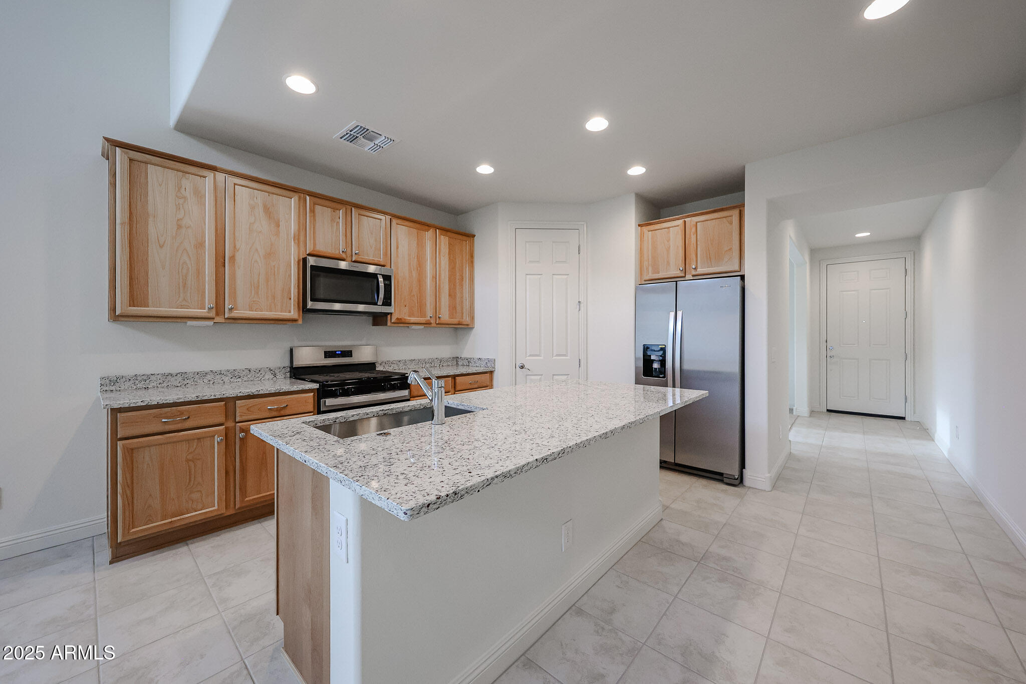 7072 West Oberlin Way Peoria, AZ 85383 - Photo 4 of 24 a kitchen with stainless steel appliances granite countertop a refrigerator stove microwave and sink