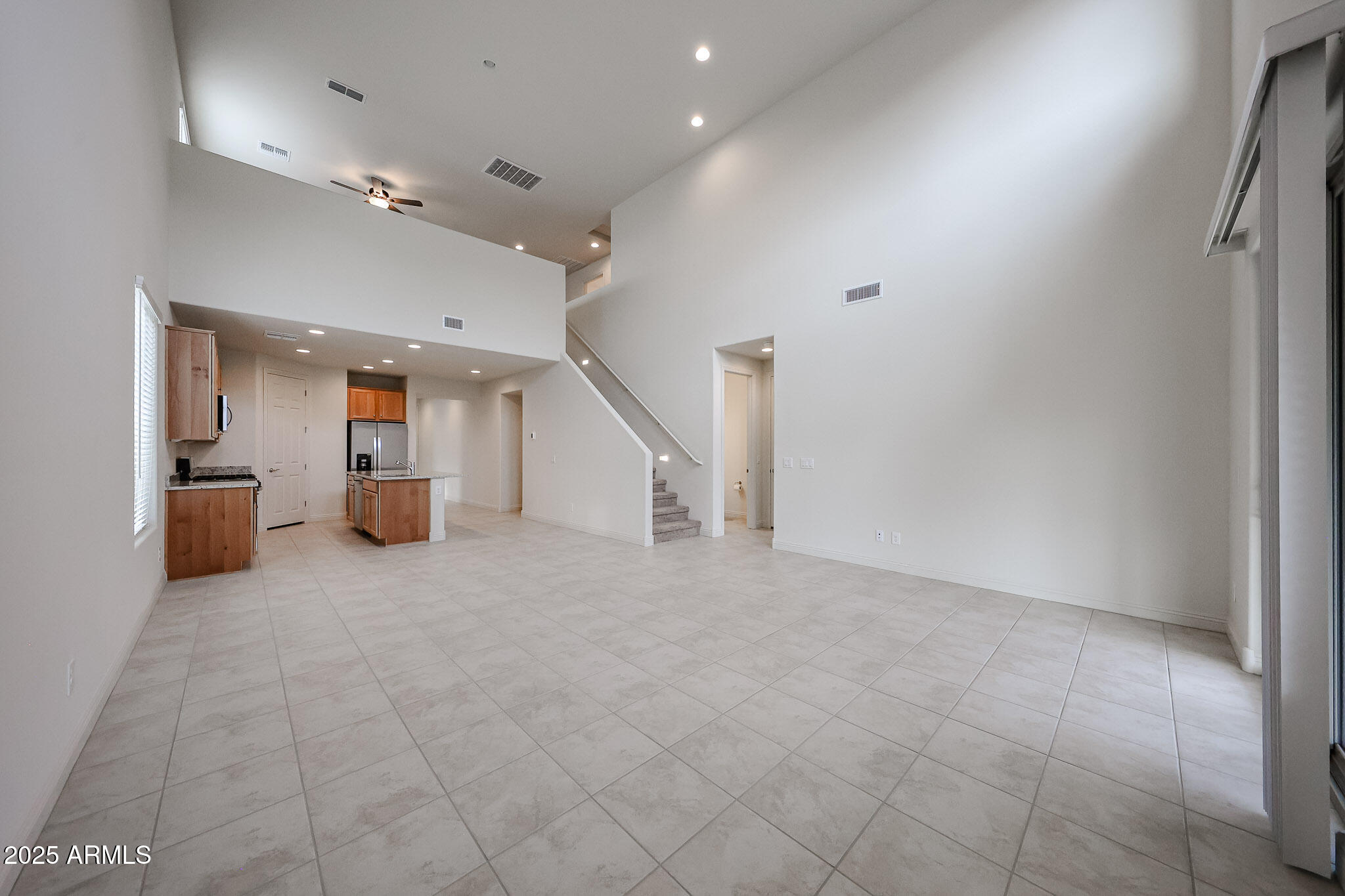 7072 West Oberlin Way Peoria, AZ 85383 - Photo 7 of 24 an empty room with staircase and white walls