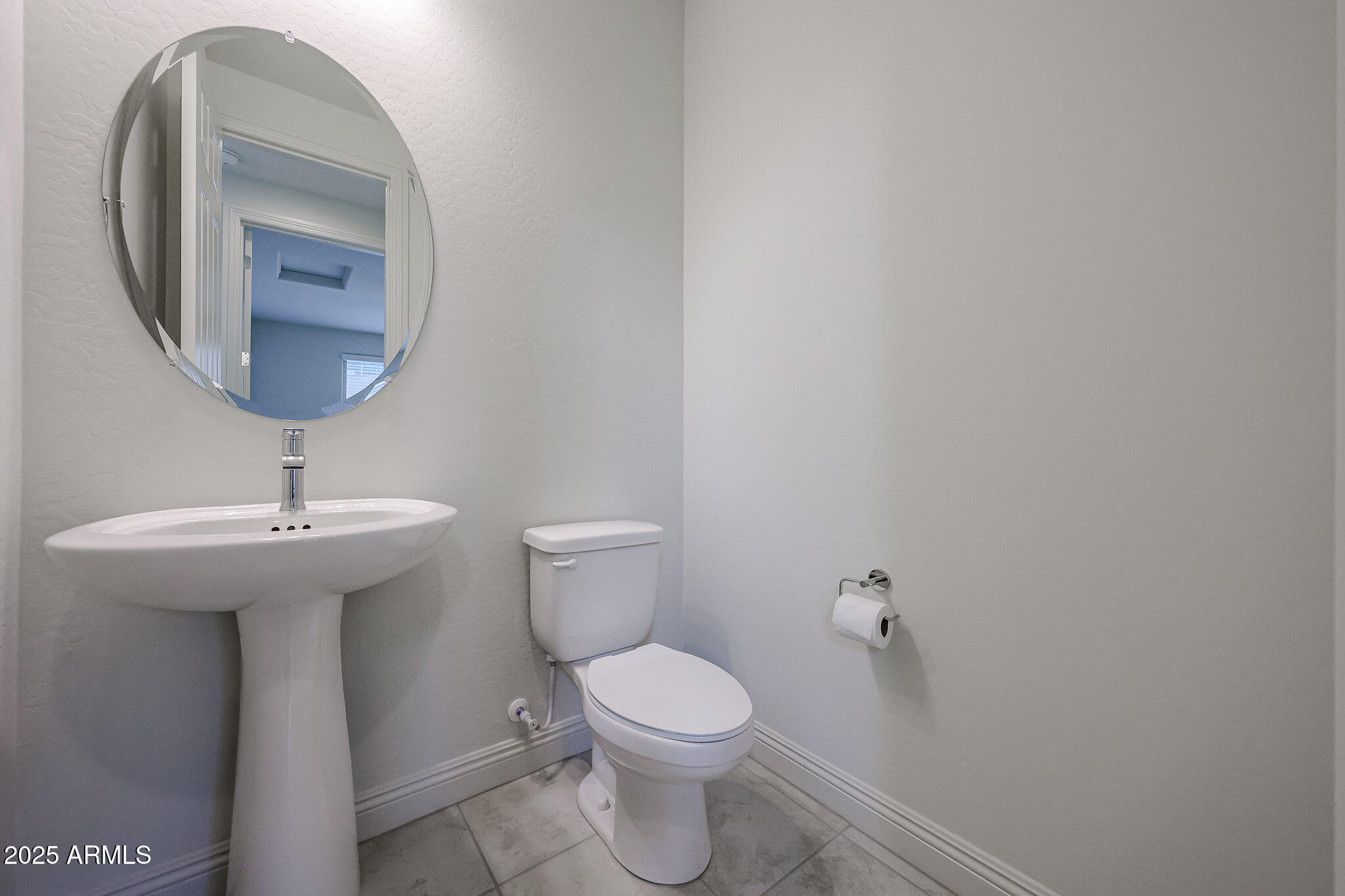 7072 West Oberlin Way Peoria, AZ 85383 - Photo 9 of 24 a bathroom with a toilet a sink and mirror