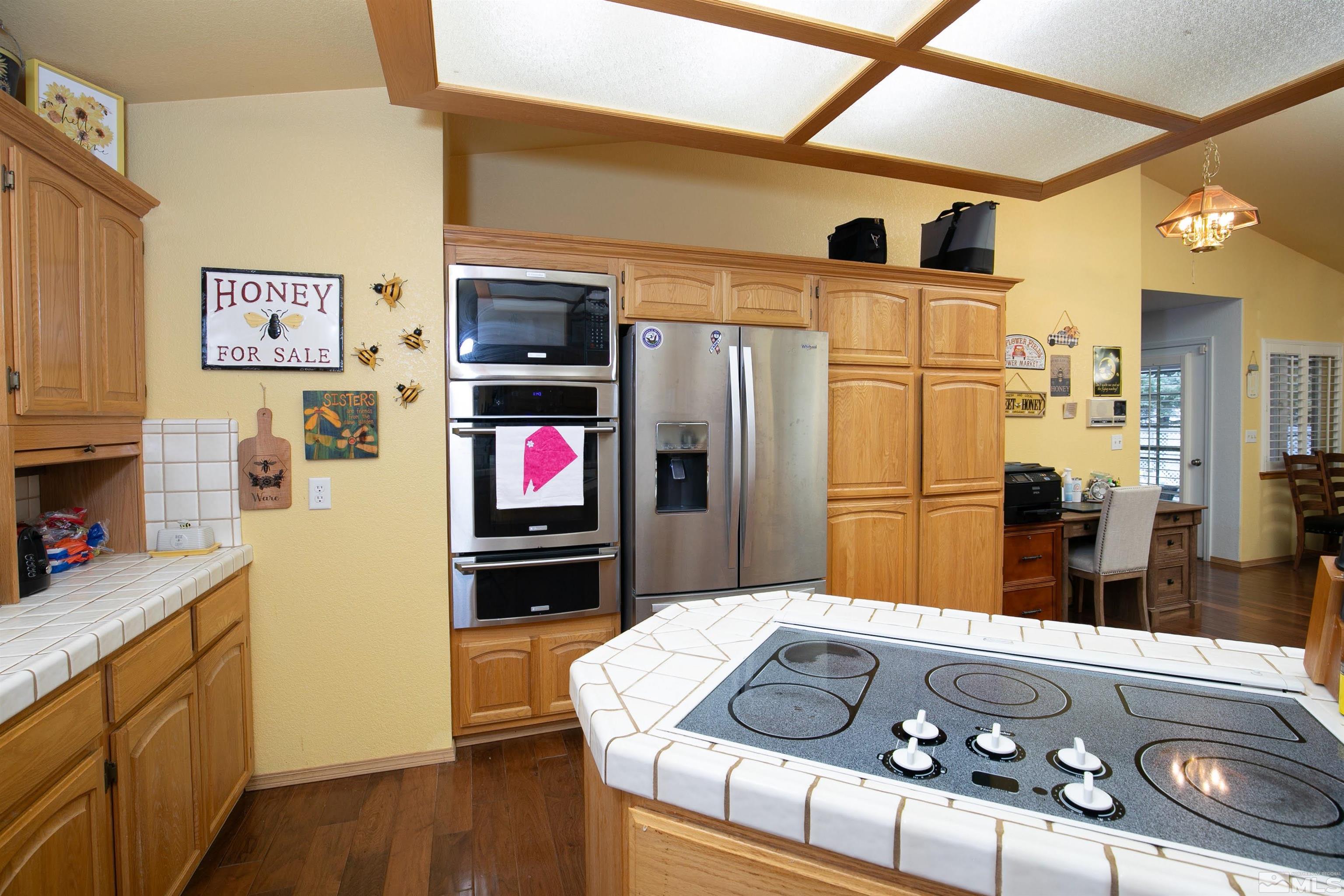5650 Rivers Edge Drive Fallon, NV 89406 - Photo 8 of 35 a kitchen with stainless steel appliances granite countertop a refrigerator a stove and a sink with wooden floor