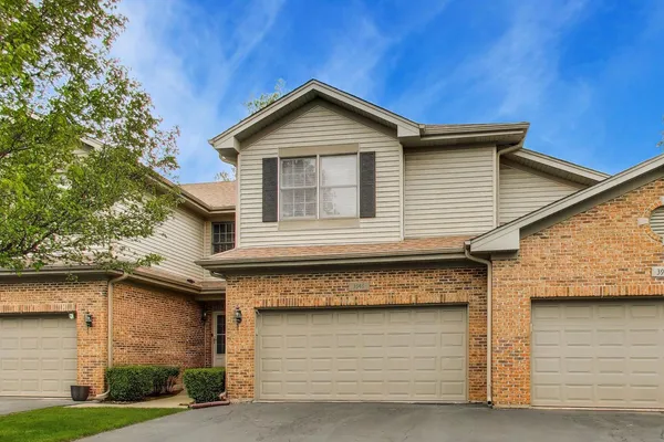 a front view of a house with garage