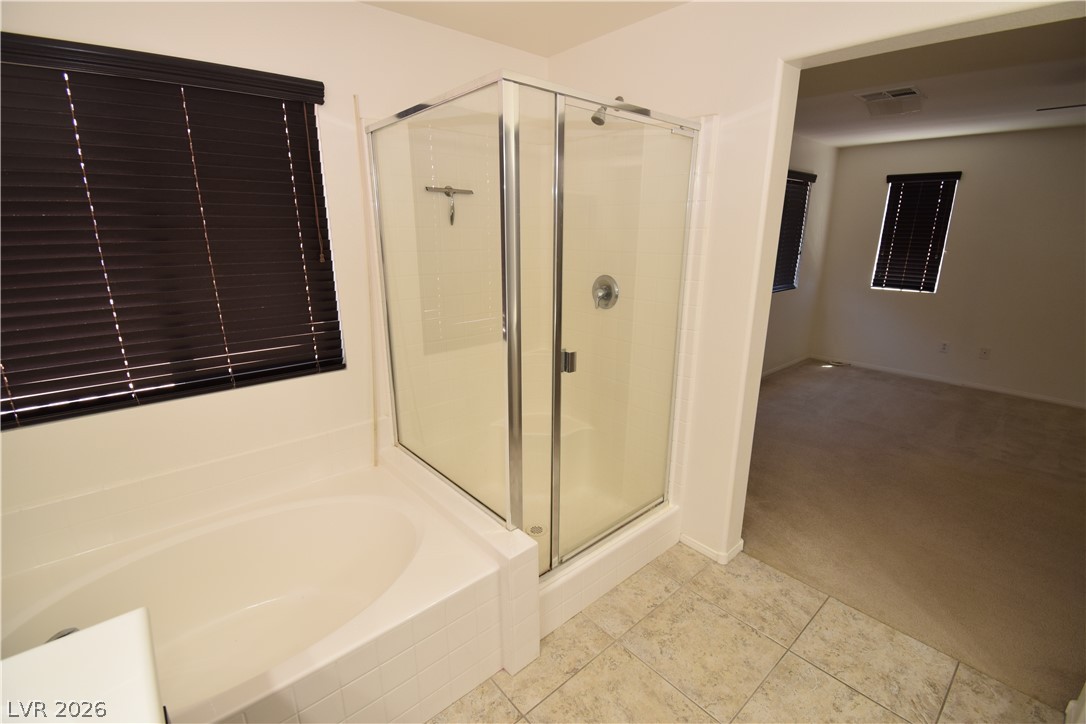 3622 Via Terracina Henderson, NV 89052 - Photo 16 of 22 Indulge in a dedicated primary bath with a spacious soaking tub and a sleek glass-enclosed shower.