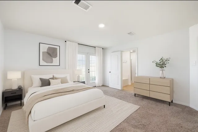 a bedroom with a white bed and a chandelier