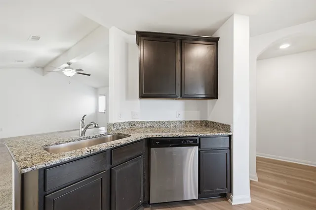 a bathroom with a granite countertop sink a large mirror and vanity