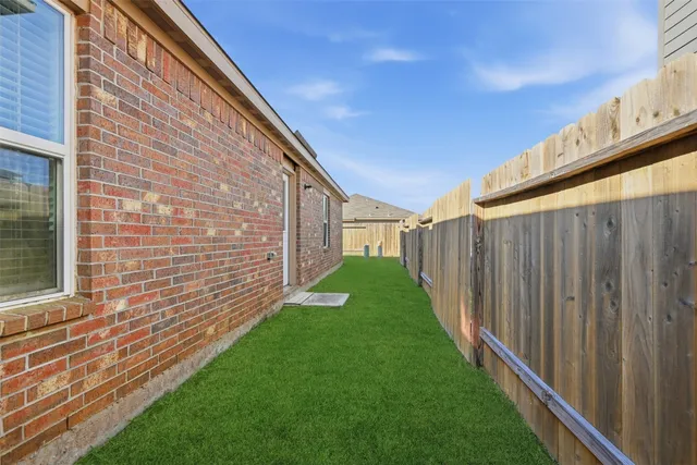 a view of a backyard with wooden fence