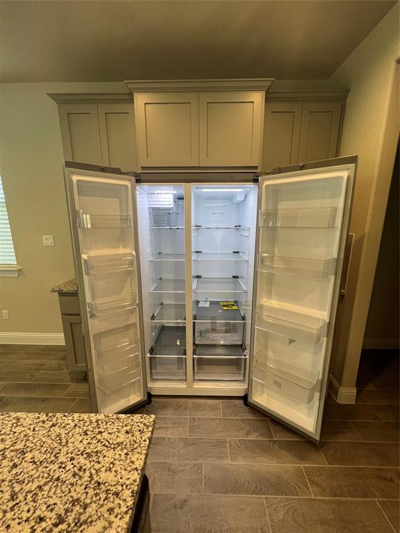 128 Free Stone Drive Georgetown, TX 78628 - Photo 24 of 29 Built-in stainless steel side-by-side refrigerator, integrated within light grey shaker-style cabinetry with crown molding