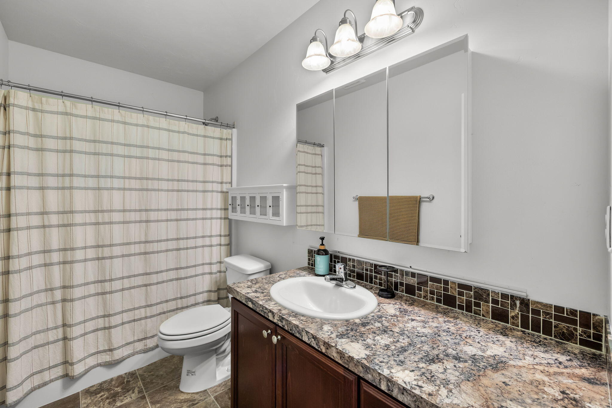 63639 Gentry Loop Bend, OR 97701 - Photo 26 of 40 a bathroom with a granite countertop sink toilet and mirror