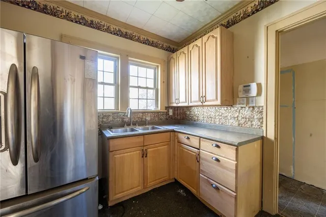 a kitchen with a sink and refrigerator