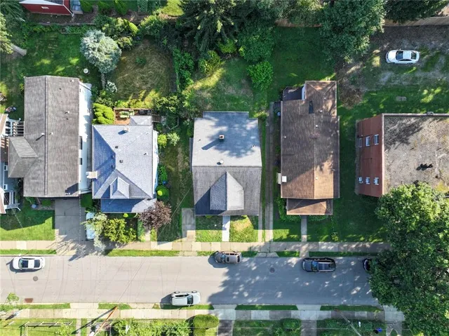 an aerial view of multiple houses with yard