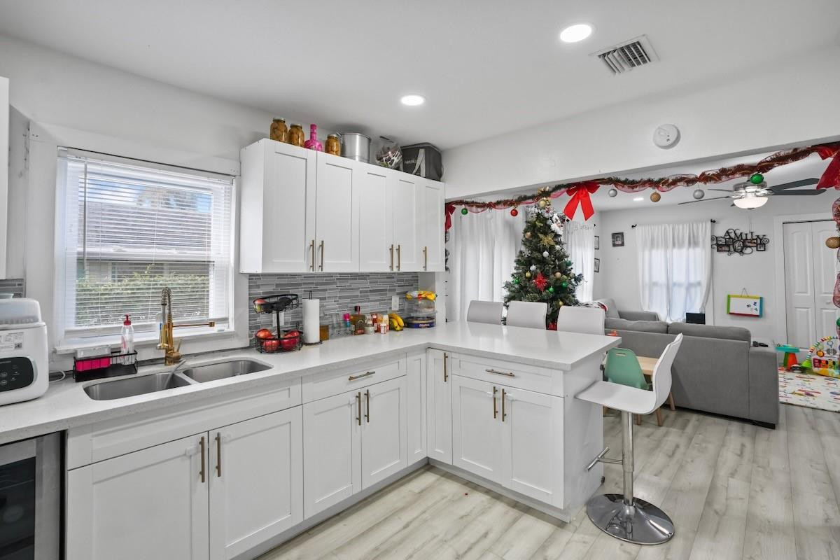 708 Northwest 15th Street Homestead, FL 33030 - Photo 12 of 32 a open kitchen with sink cabinets and wooden floor