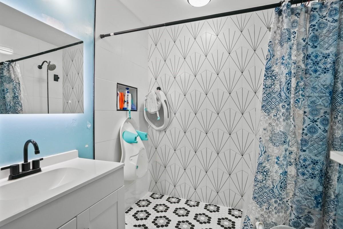 708 Northwest 15th Street Homestead, FL 33030 - Photo 22 of 32 a bathroom with a sink and a mirror