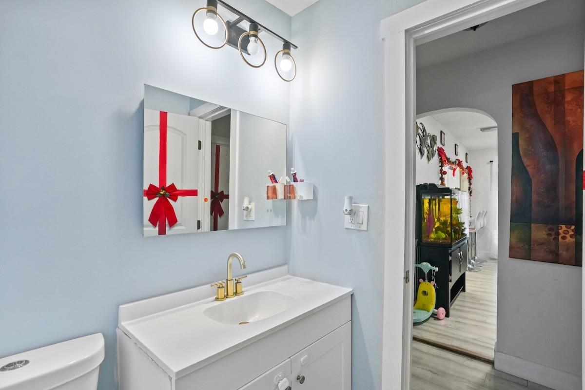 708 Northwest 15th Street Homestead, FL 33030 - Photo 23 of 32 a bathroom with a sink mirror and vanity