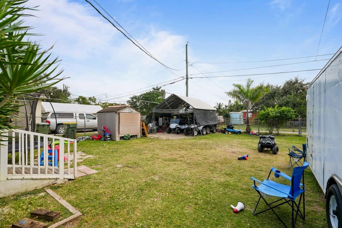 708 Northwest 15th Street Homestead, FL 33030 - Photo 28 of 32 a house view with a sitting space fire pit and outdoor space