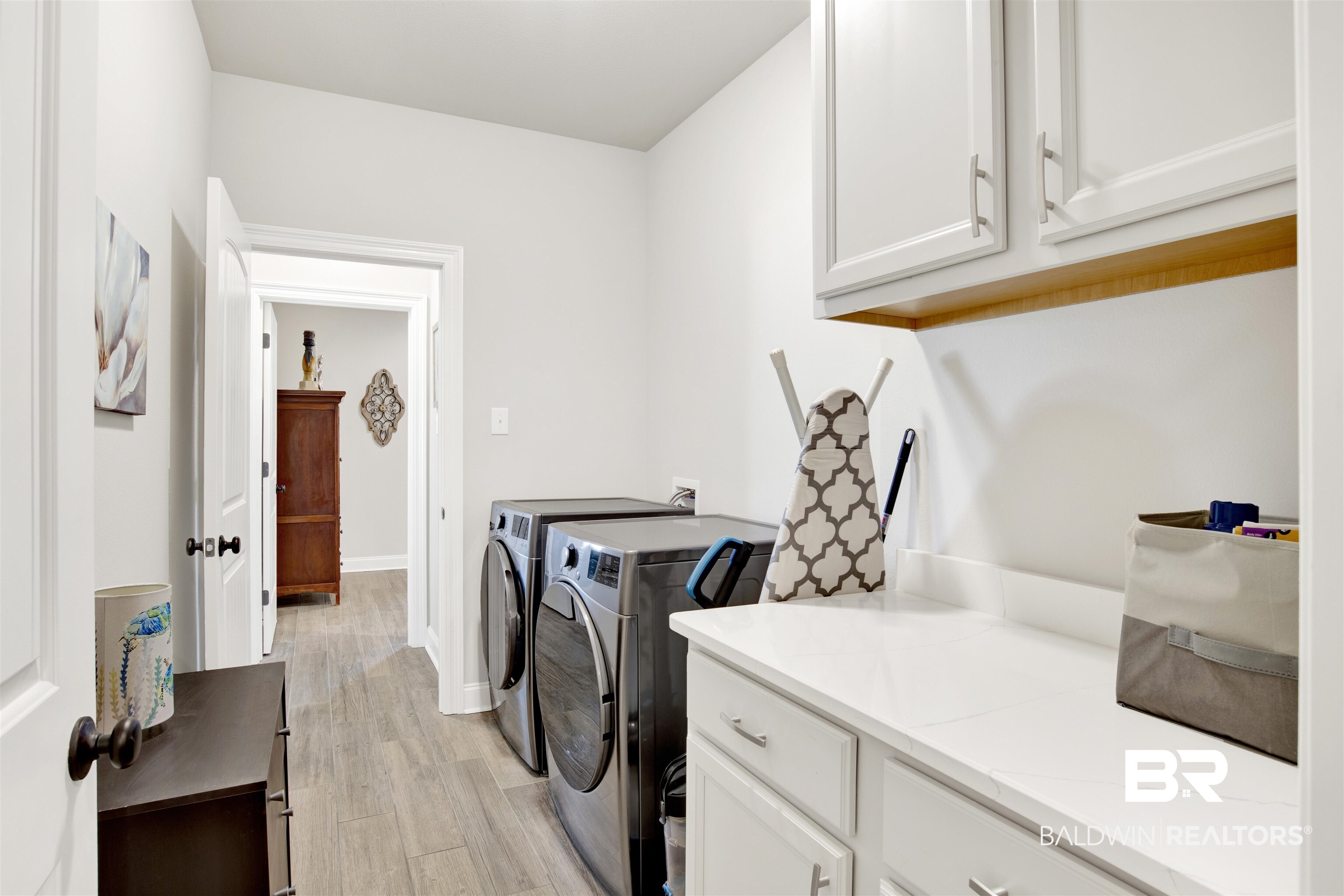 1406 Aldon Street Foley, AL 36535 - Photo 22 of 30 Washroom featuring cabinets, luxury wood-like tile flooring and washing machine and clothes dryer