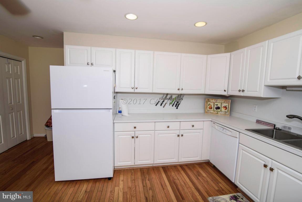 17 Mist Flower Road Ocean Pines, MD 21811 - Photo 11 of 49 a kitchen with granite countertop white cabinets and white appliances