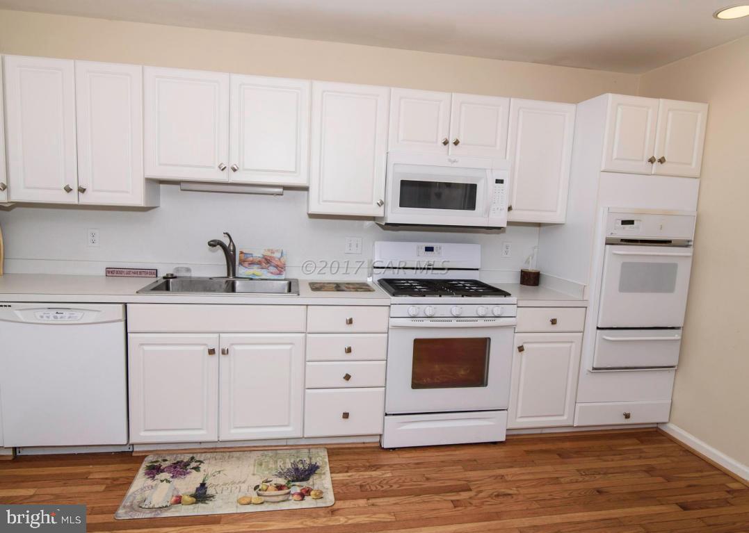17 Mist Flower Road Ocean Pines, MD 21811 - Photo 12 of 49 a kitchen with granite countertop white cabinets and white appliances