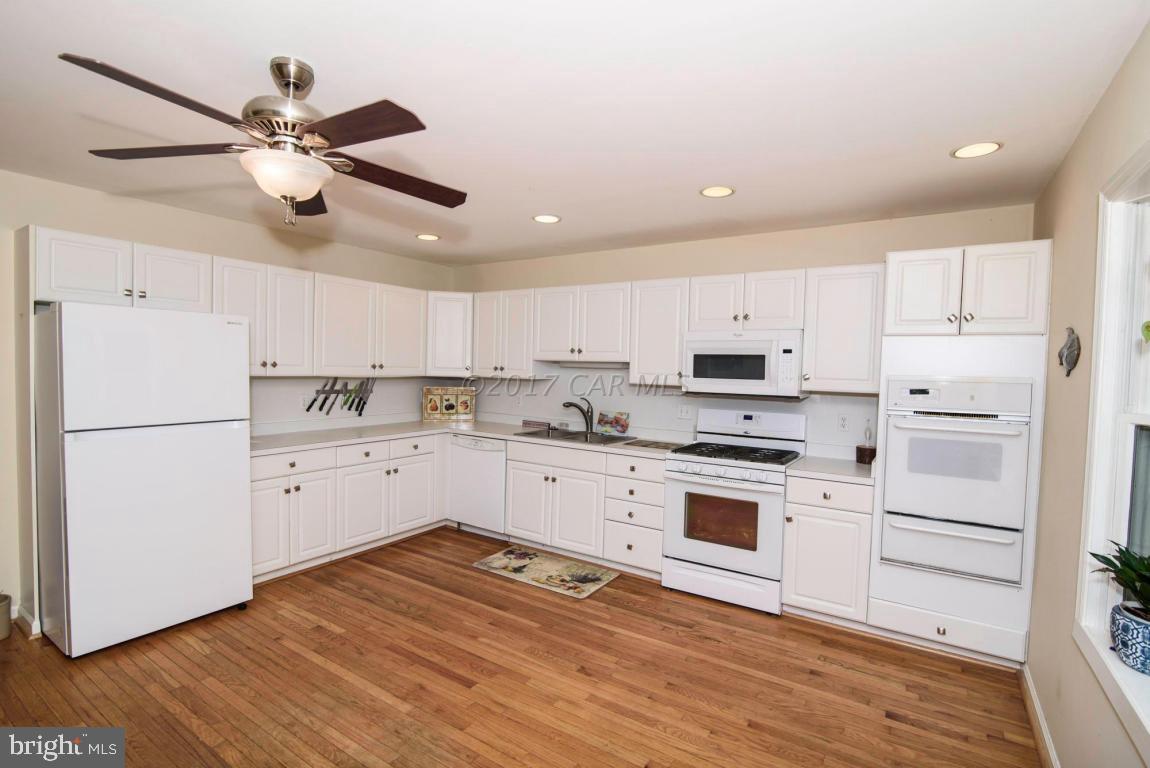 17 Mist Flower Road Ocean Pines, MD 21811 - Photo 4 of 49 a kitchen with cabinets stainless steel appliances and wooden floor