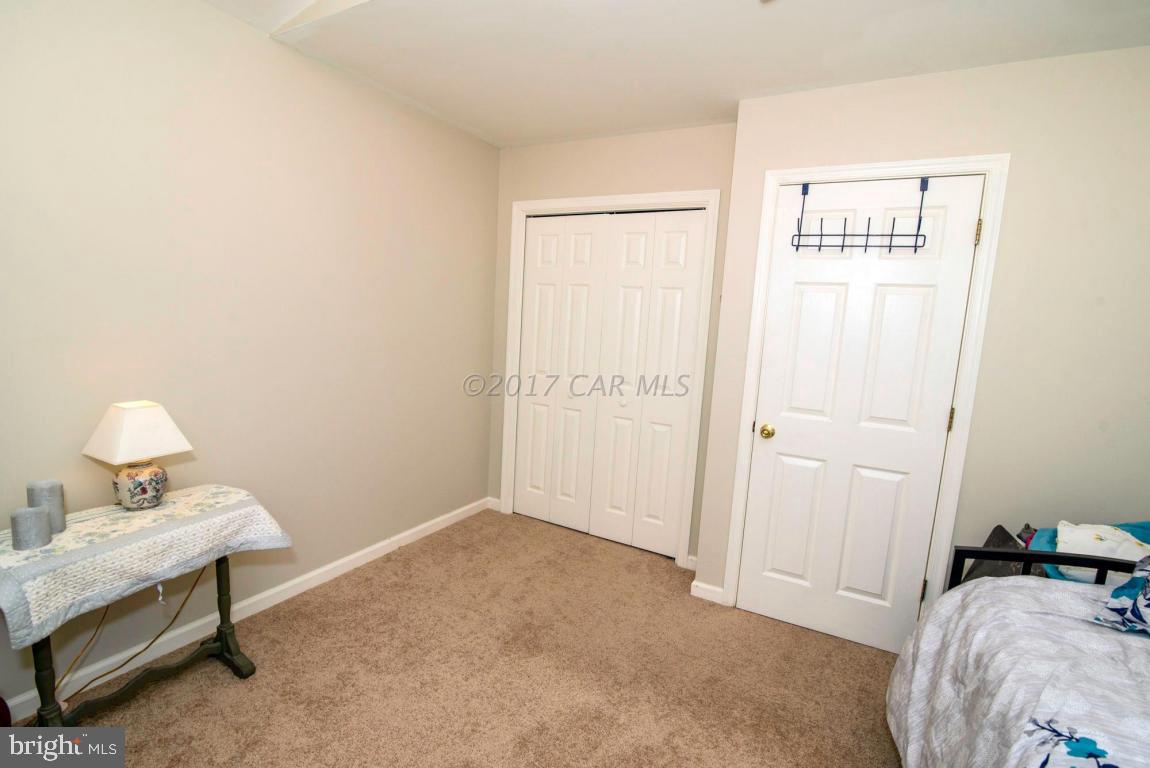 17 Mist Flower Road Ocean Pines, MD 21811 - Photo 37 of 49 a bedroom with a bed and a lamp on table