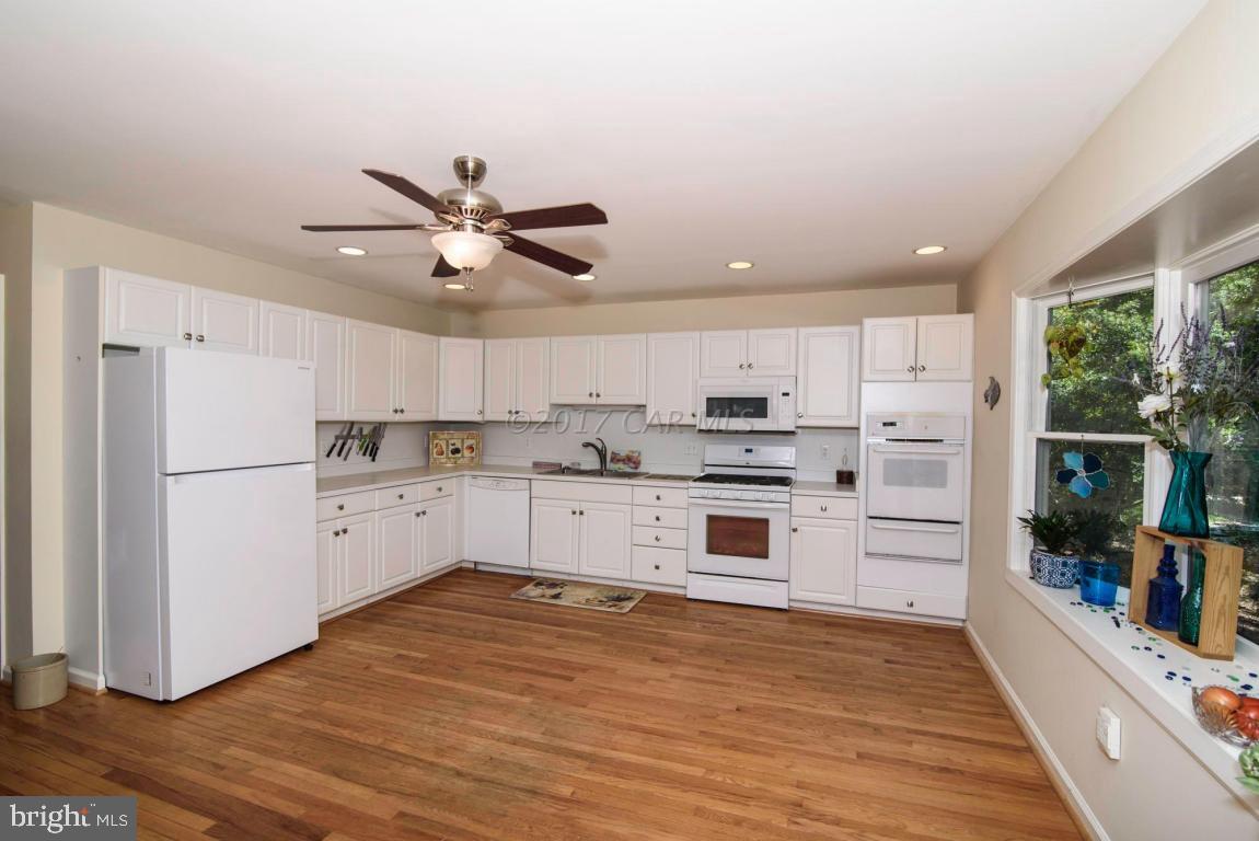 17 Mist Flower Road Ocean Pines, MD 21811 - Photo 8 of 49 a kitchen with white cabinets and white appliances