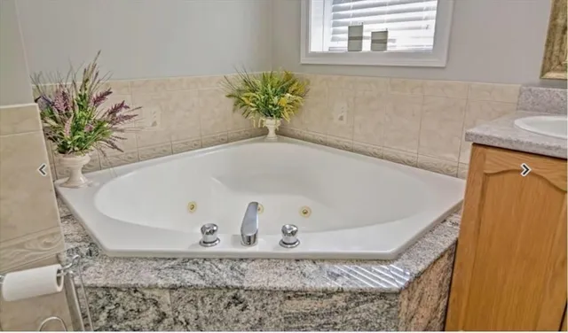 a kitchen with stainless steel appliances granite countertop a sink dishwasher stove refrigerator and cabinets