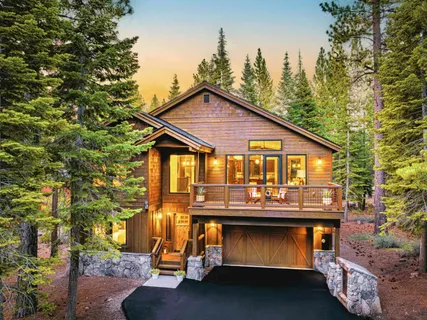 a view of a small house with roof and wooden fence