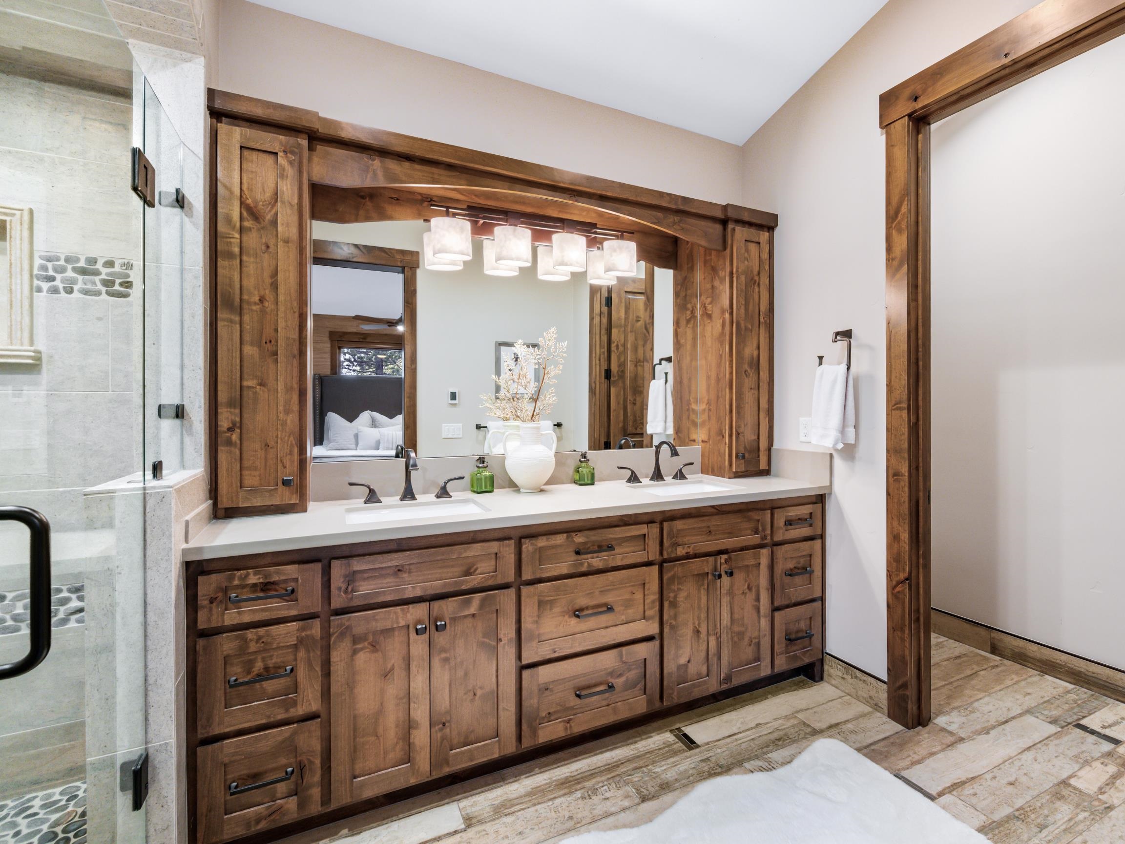 10613 Carson Range Road Truckee, CA 96161 - Photo 12 of 28 a bathroom with a granite countertop double vanity sink and a mirror
