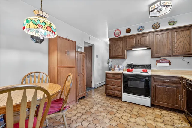 a kitchen with stainless steel appliances granite countertop a sink a stove a refrigerator and a window