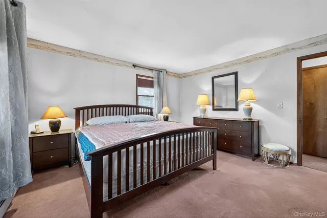 a bedroom with furniture and a window