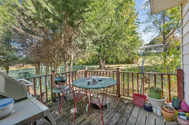 a view of a balcony with chairs and wooden floor