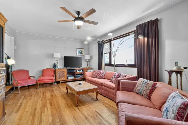 a living room with furniture wooden floor and a flat screen tv