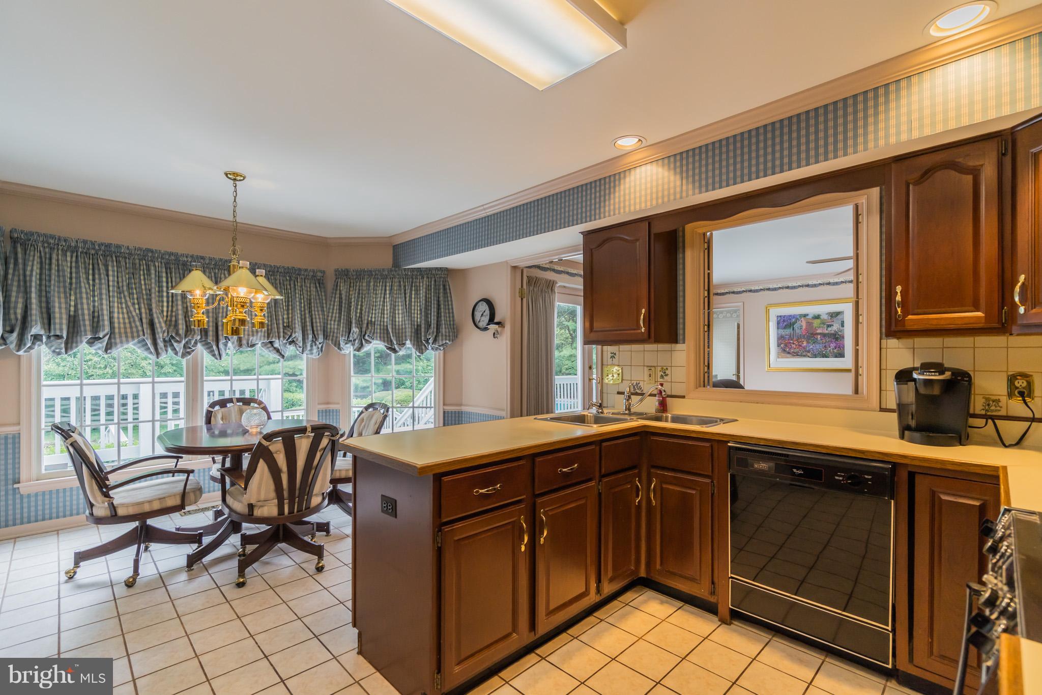 14615 Manor Road Phoenix, MD 21131 - Photo 14 of 43 a kitchen with a table chairs sink and cabinets
