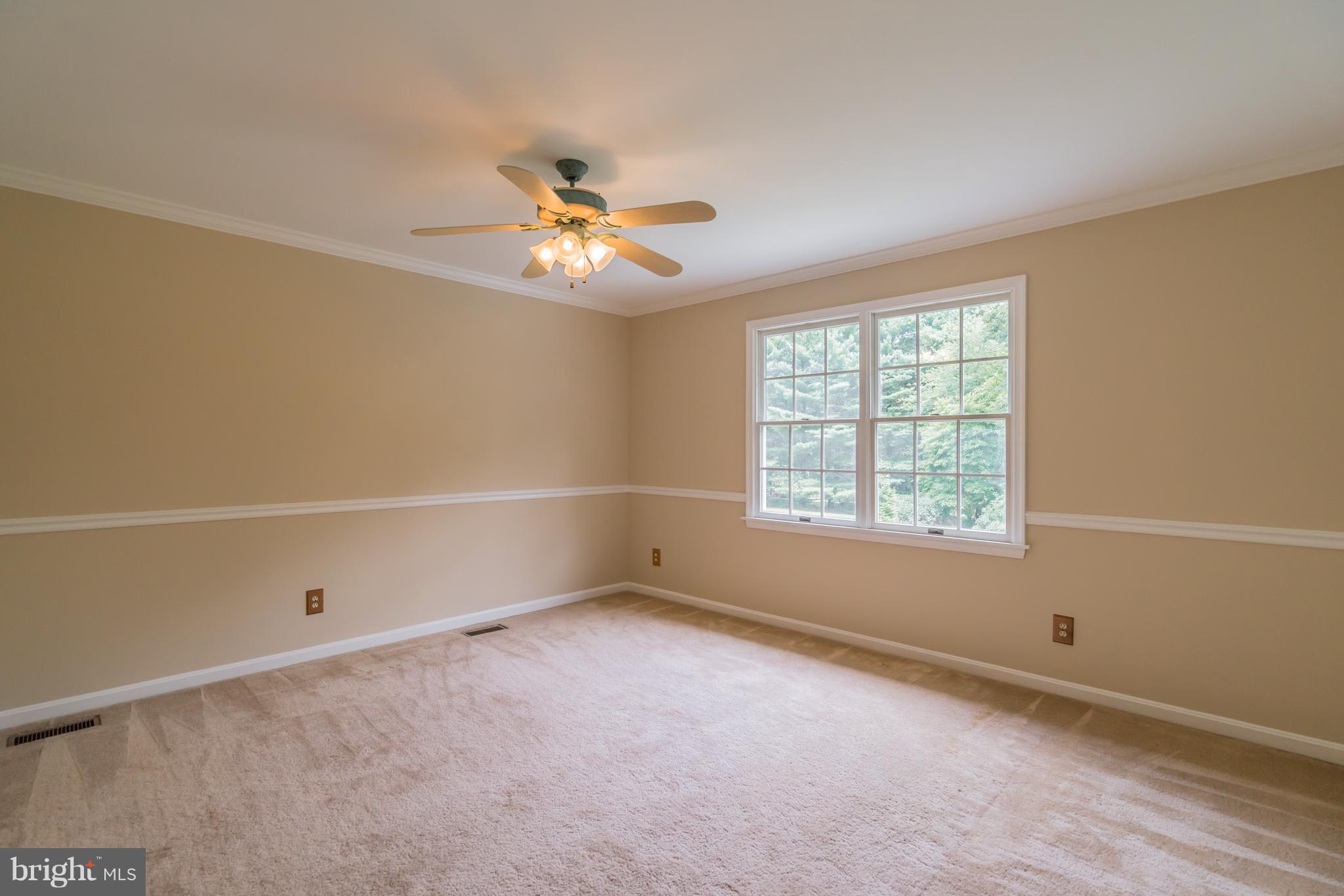 14615 Manor Road Phoenix, MD 21131 - Photo 22 of 43 an empty room with a window and ceiling fan