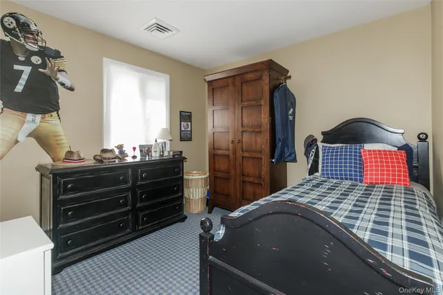 a bedroom with a bed and a dresser