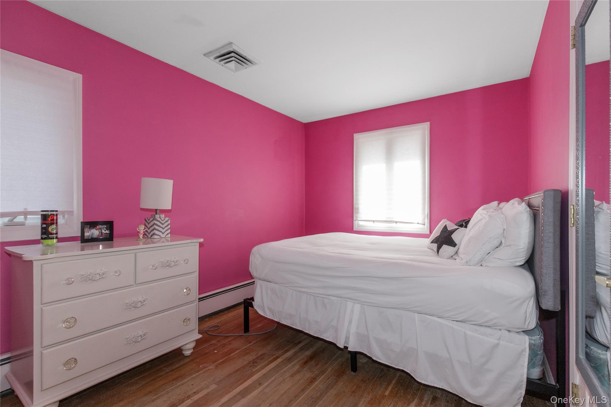 61 Mitchell Avenue Plainview, NY 11803 - Photo 12 of 24 a bedroom with a bed and a dresser