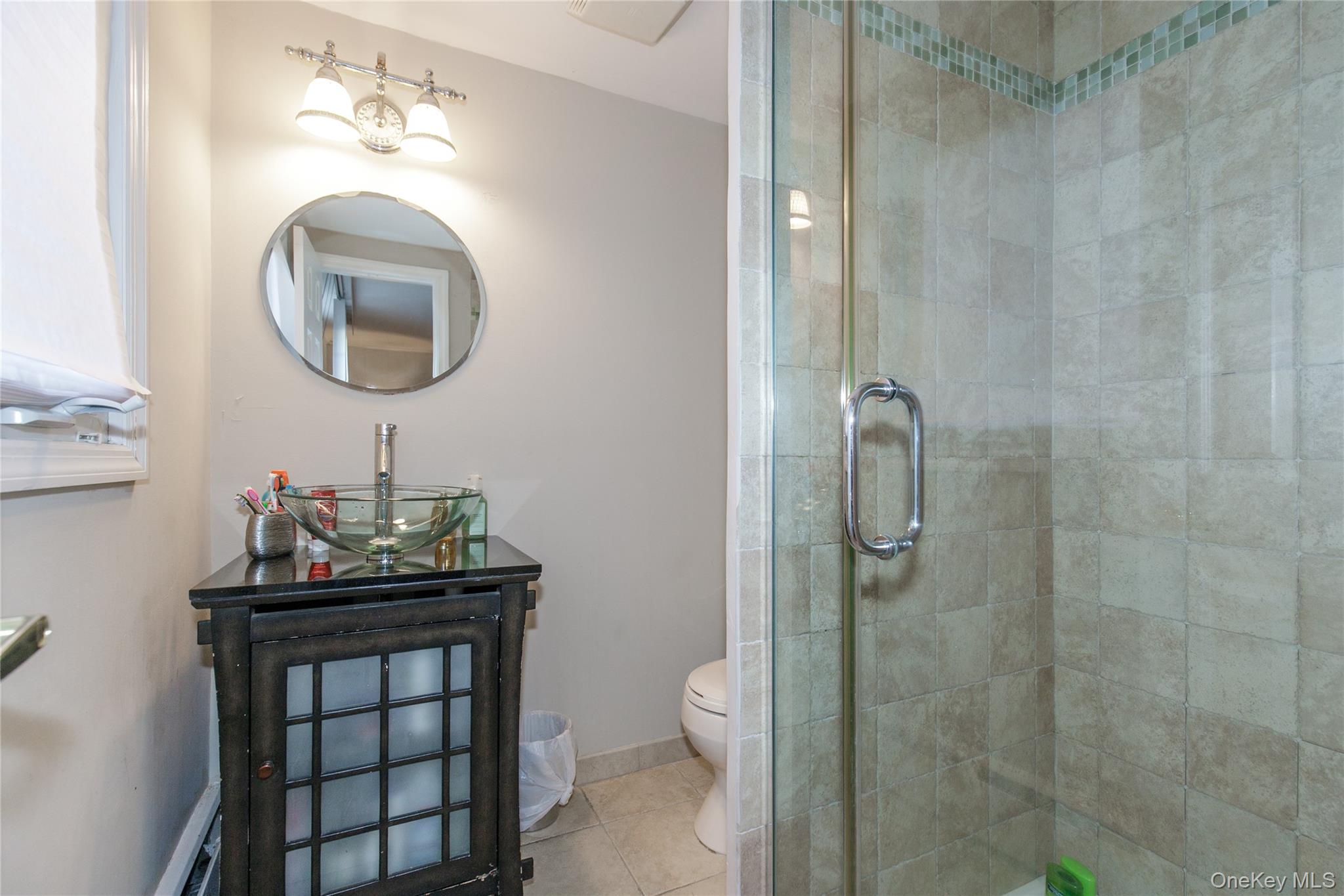 61 Mitchell Avenue Plainview, NY 11803 - Photo 17 of 24 a bathroom with a toilet sink and mirror