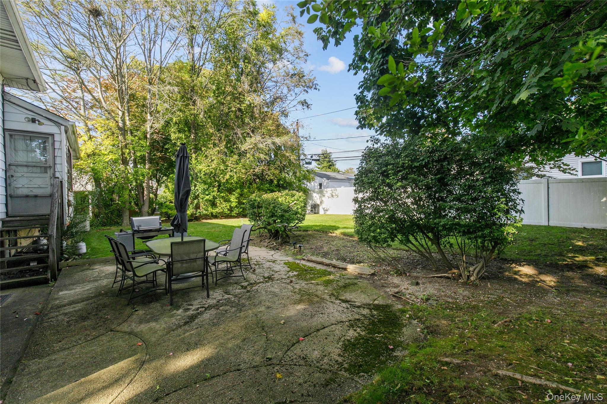 61 Mitchell Avenue Plainview, NY 11803 - Photo 22 of 24 a view of a backyard with sitting area