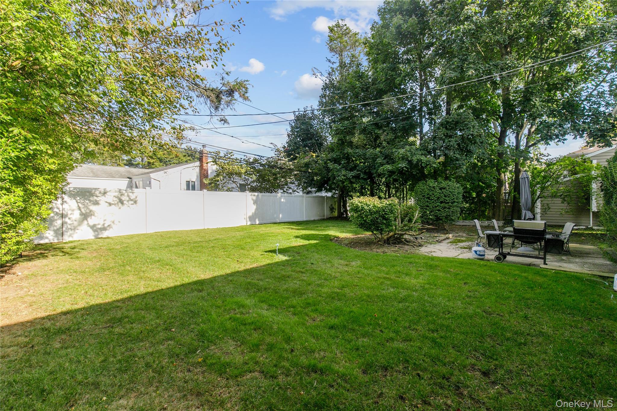 61 Mitchell Avenue Plainview, NY 11803 - Photo 23 of 24 a view of a house with a yard porch and sitting area