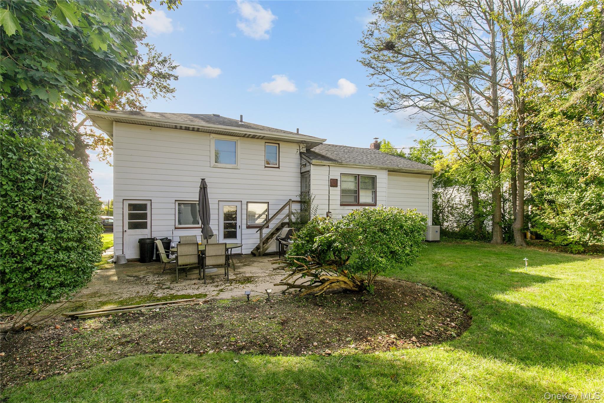 61 Mitchell Avenue Plainview, NY 11803 - Photo 24 of 24 a view of a house with backyard and sitting area