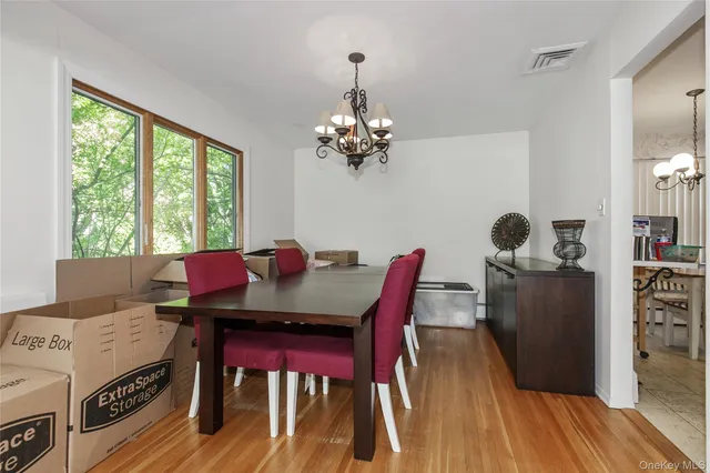 a view of a dining room with furniture window and wooden floor