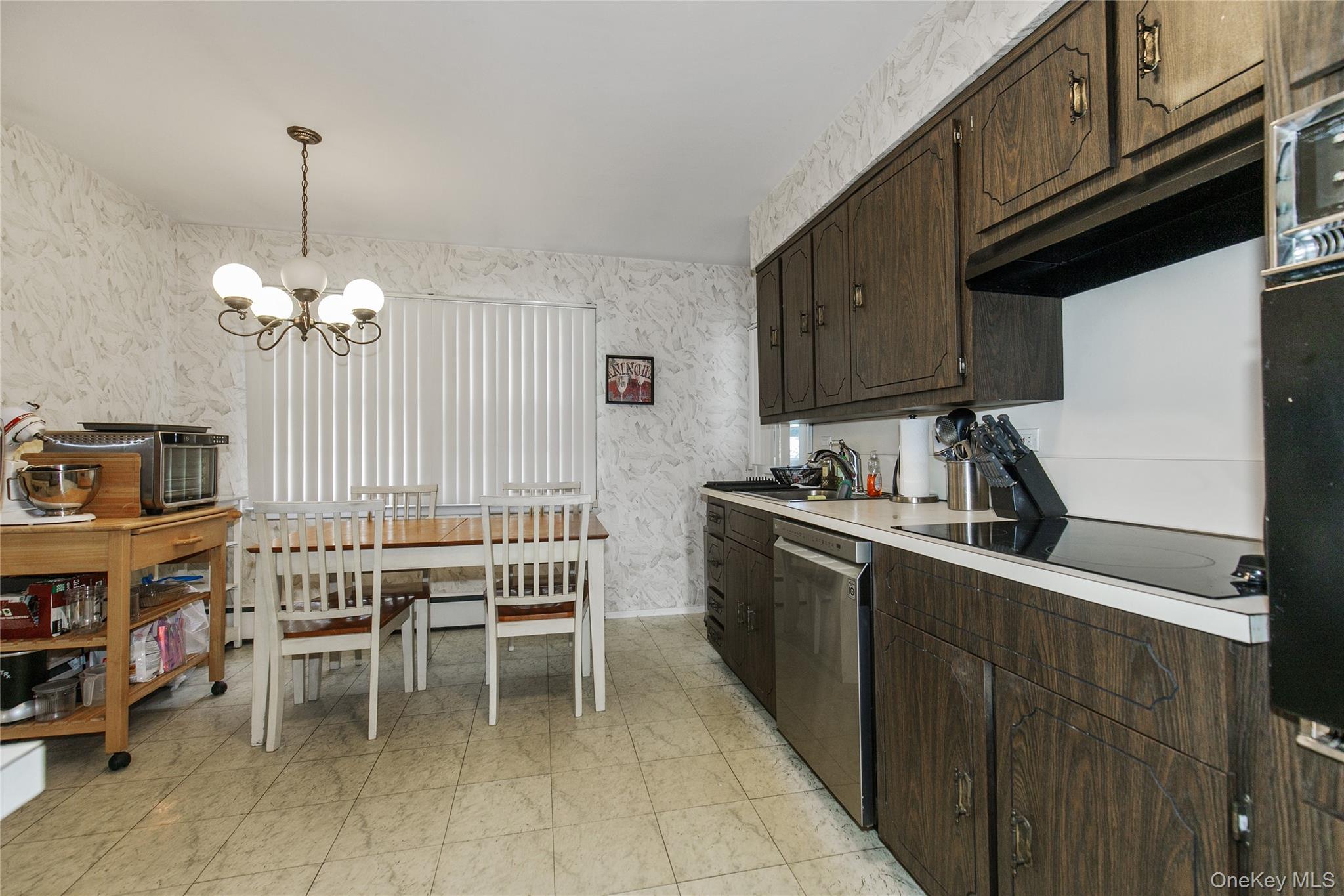 61 Mitchell Avenue Plainview, NY 11803 - Photo 6 of 24 a kitchen with furniture a refrigerator and a stove