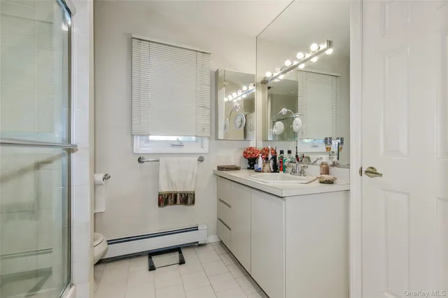 a bathroom with a sink vanity and a mirror