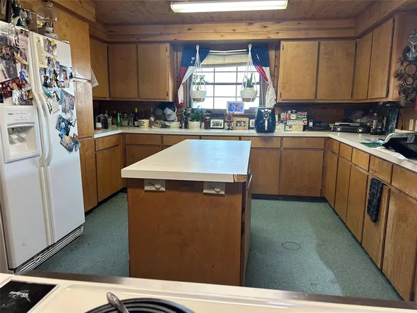 a dining room with furniture and a floor to ceiling window