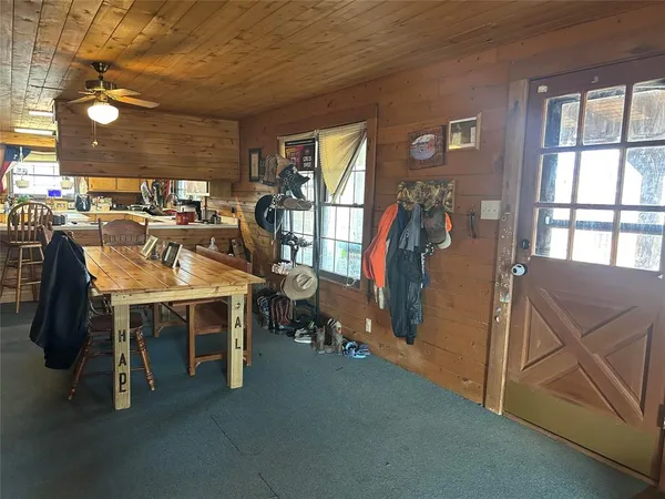 a view of a hallway with stairs and furniture