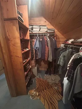 a bedroom with furniture and a air conditioner vent