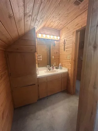 a bathroom with a double vanity sink and mirror