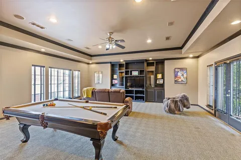 a living room with furniture a window and gym equipment