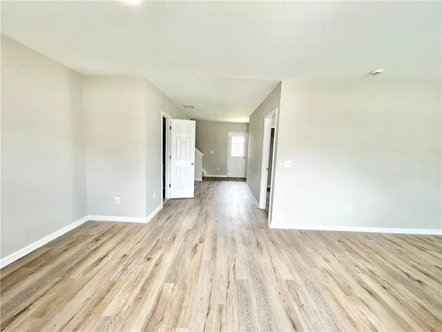 a view of a room with wooden floor and a toilet